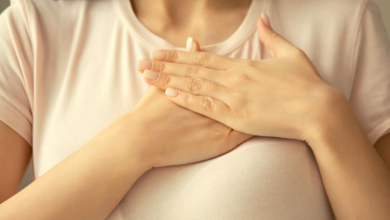 Two hands resting on the heart, the gesture of feeling based relating
